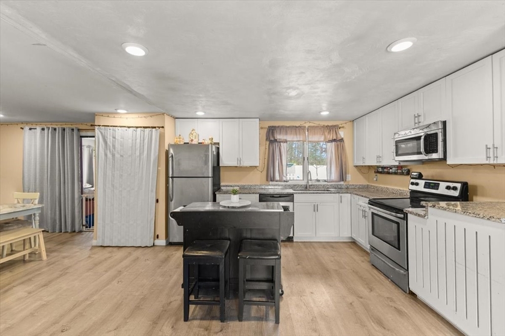40 Christopher Road Brockton, MA 02302 - Photo 5 of 28 a kitchen with a sink a counter top space stainless steel appliances and cabinets