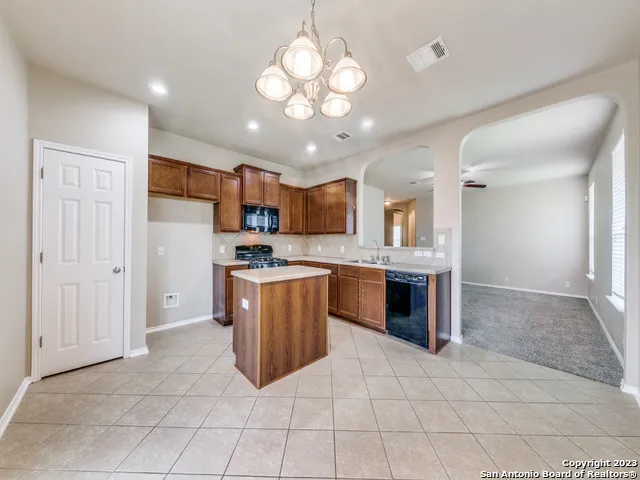 a open kitchen with cabinets a sink and stainless steel appliances