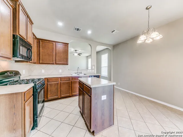 a kitchen with a sink stove and microwave