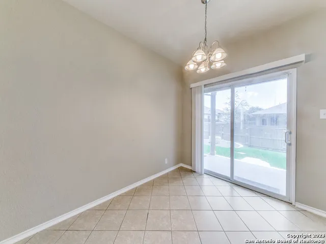 a view of backyard with swimming pool and seating space