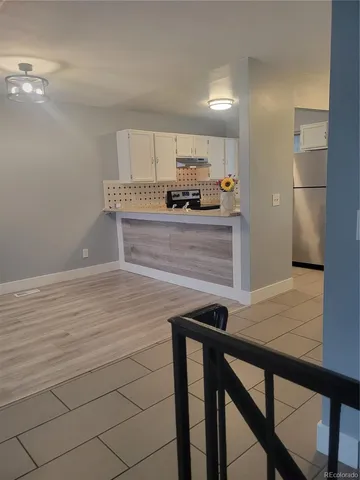 a view of kitchen with cabinets and wooden floor