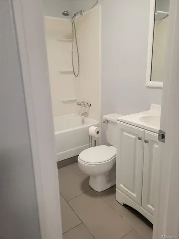 a bathroom with a toilet a sink and shower