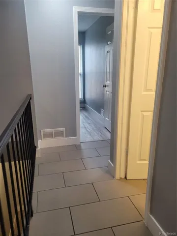 a view of a bathroom from a corridor