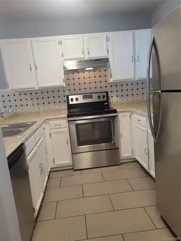 a kitchen with cabinets and appliances