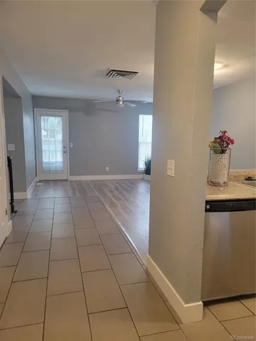 a view of a livingroom with wooden floor and a window