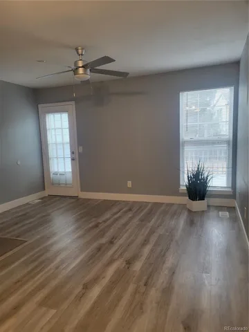 wooden floor in an empty room with a window