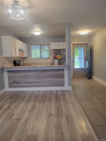 a view of kitchen with sink and window