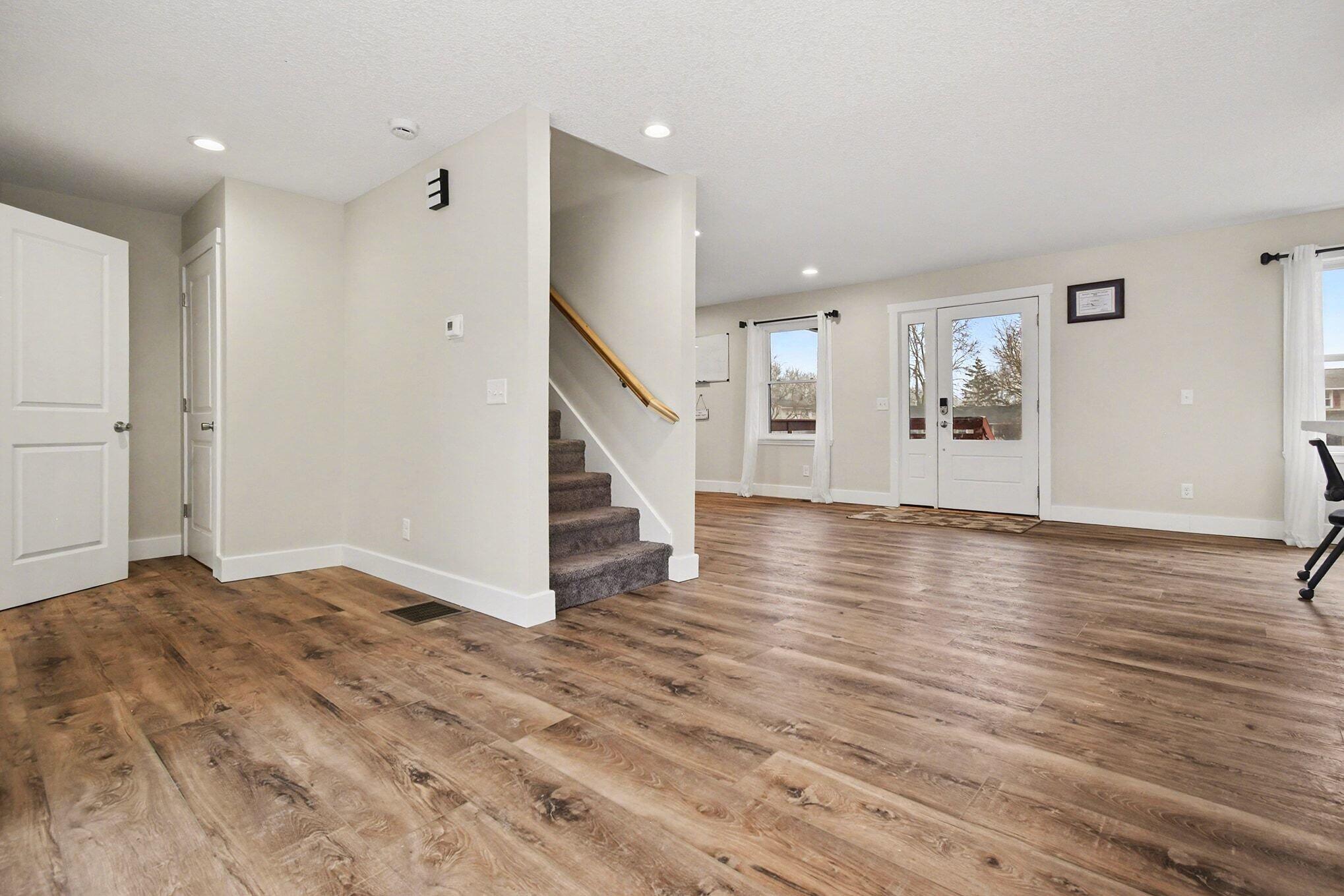 5317 Stellhorn Road Fort Wayne, IN 46815 - Photo 12 of 29 a view of an empty room with wooden floor and stairs