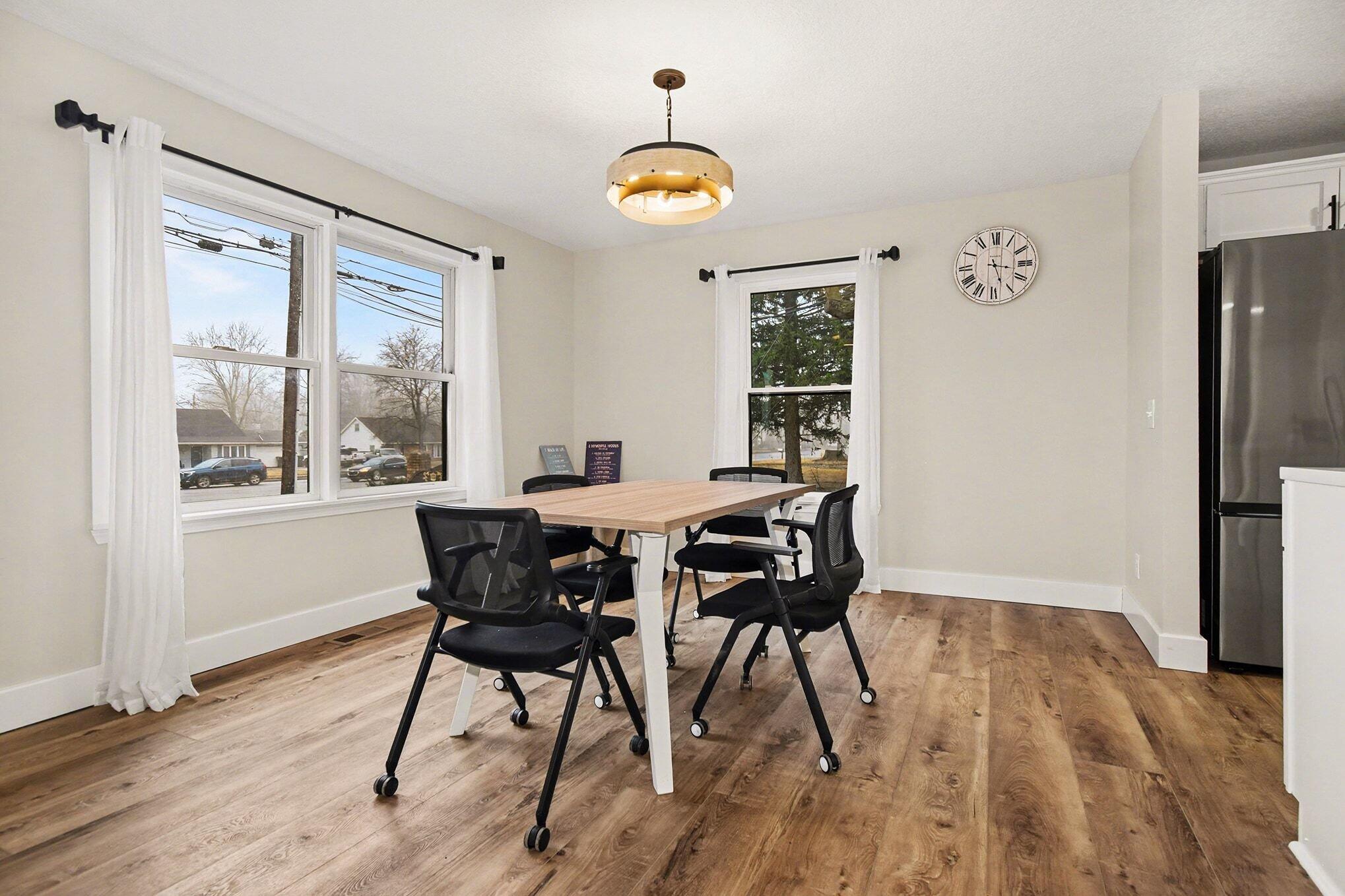 5317 Stellhorn Road Fort Wayne, IN 46815 - Photo 14 of 29 a dining room with furniture a chandelier and wooden floor