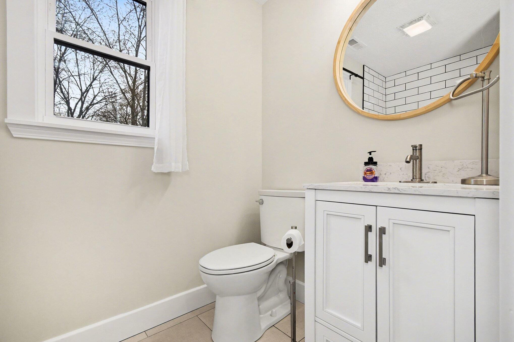 5317 Stellhorn Road Fort Wayne, IN 46815 - Photo 25 of 29 a bathroom with a toilet sink vanity and mirror