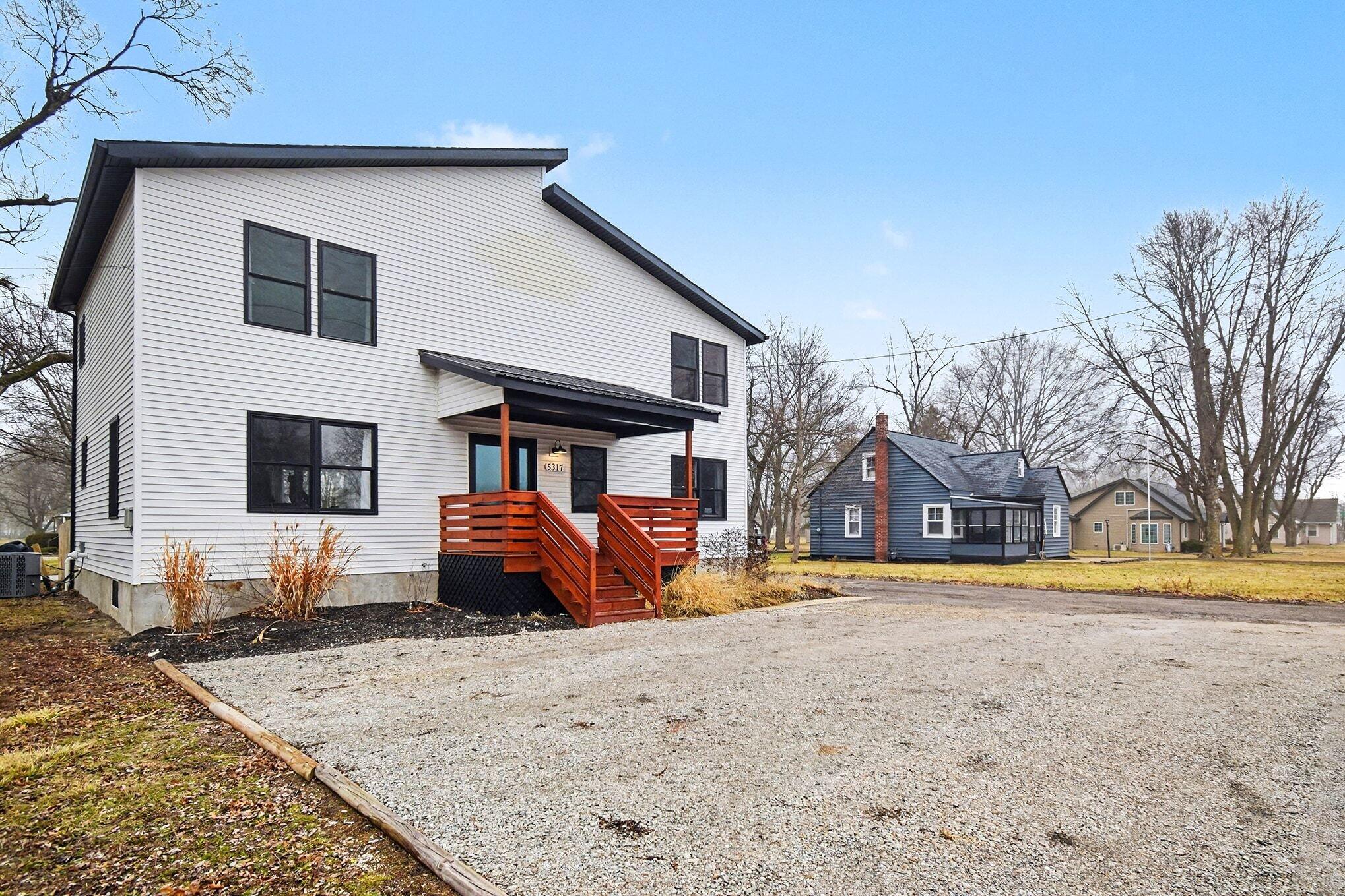 5317 Stellhorn Road Fort Wayne, IN 46815 - Photo 3 of 29 a front view of a house with a yard covered in snow