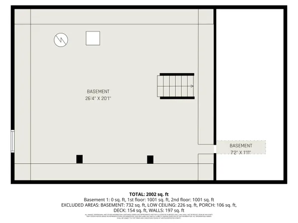 a view of an empty room with wooden floor and stairs