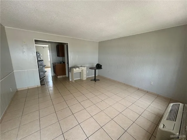 a view of an empty room and fire place