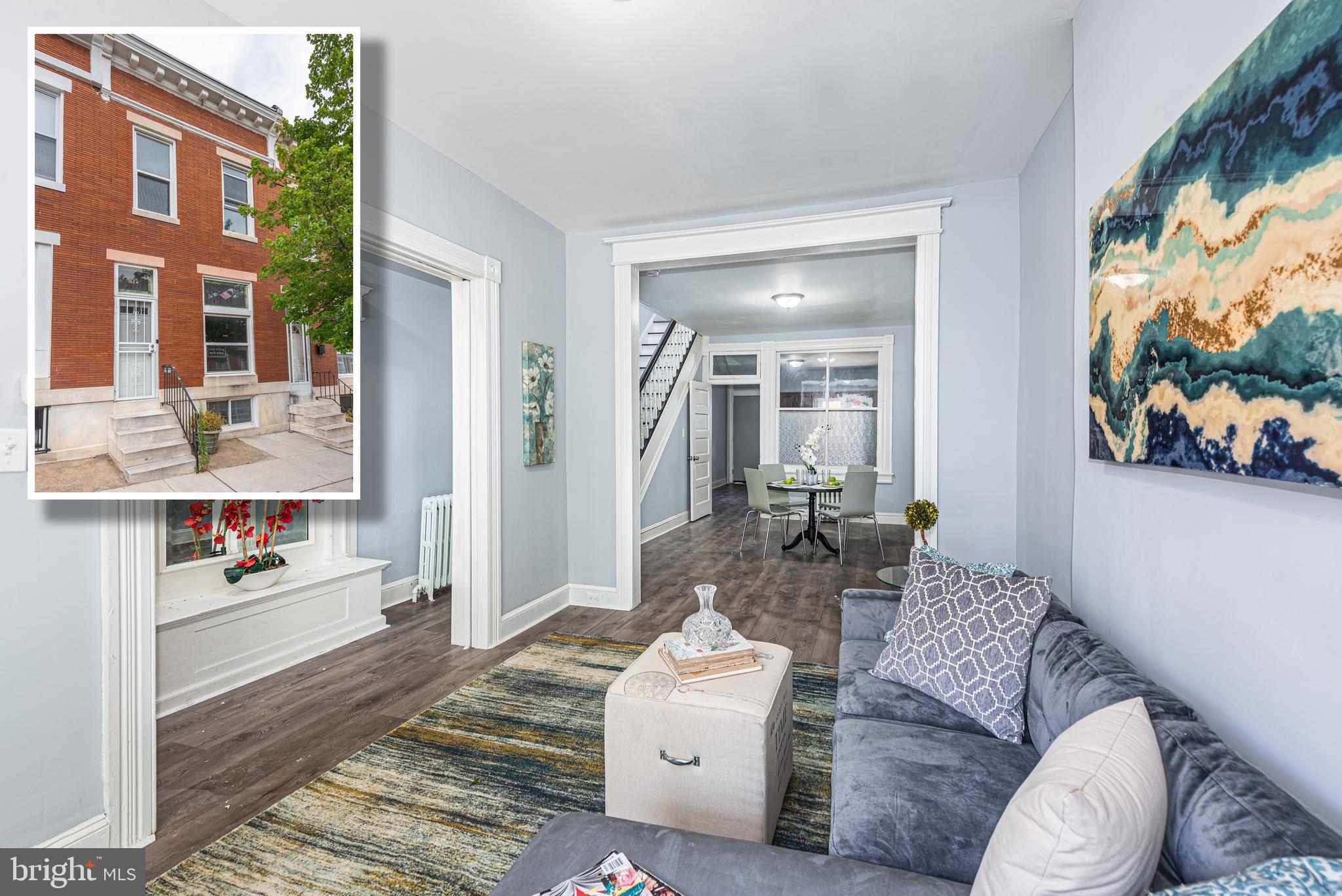 a living room with furniture and a floor to ceiling window