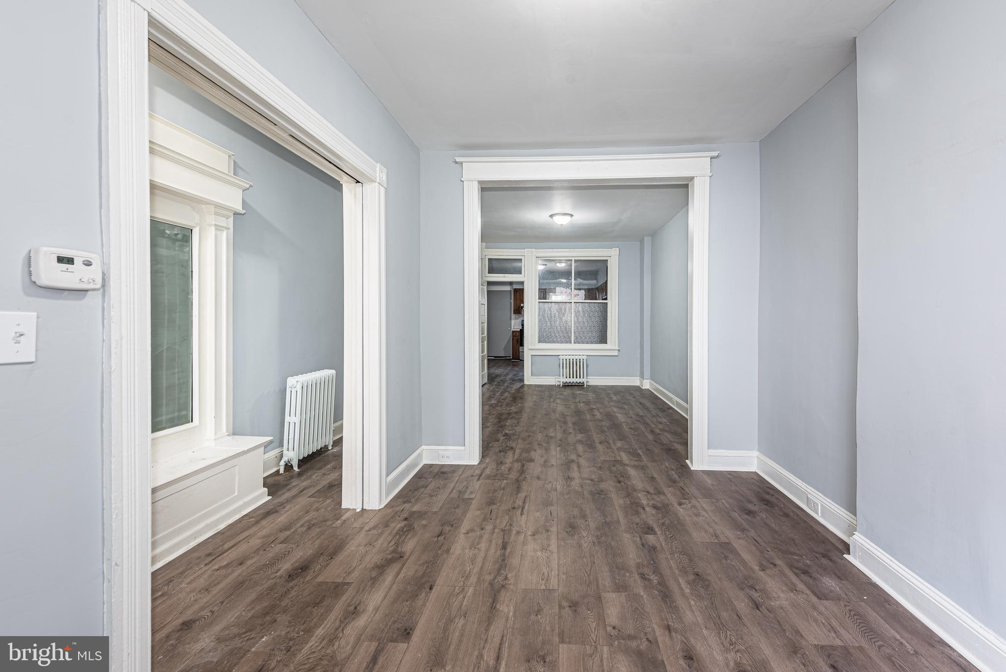 1624 Darley Avenue Baltimore, MD 21213 - Photo 11 of 28 a view of a hallway with wooden floor and a living room