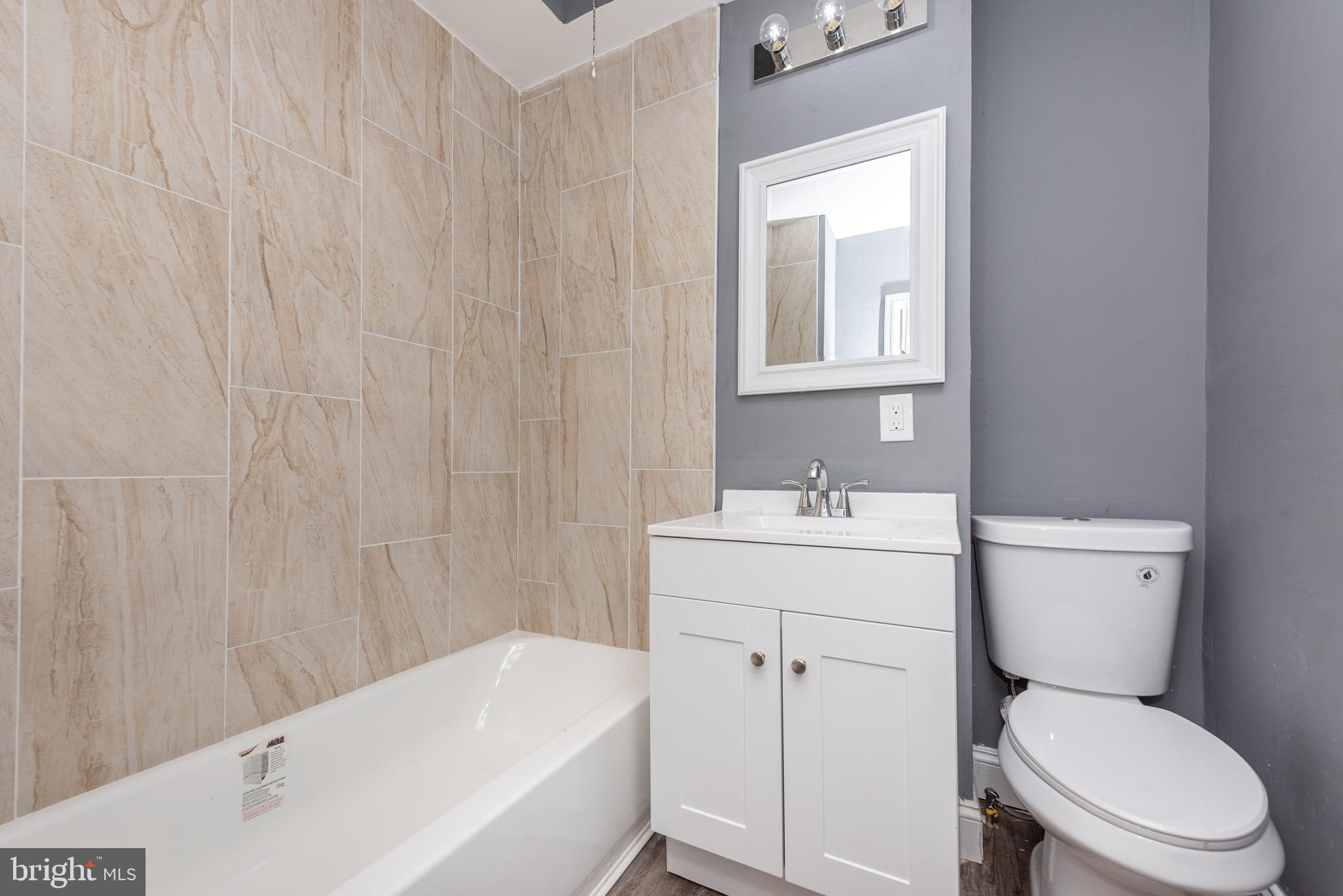 1624 Darley Avenue Baltimore, MD 21213 - Photo 22 of 28 a bathroom with a sink a toilet and bathtub