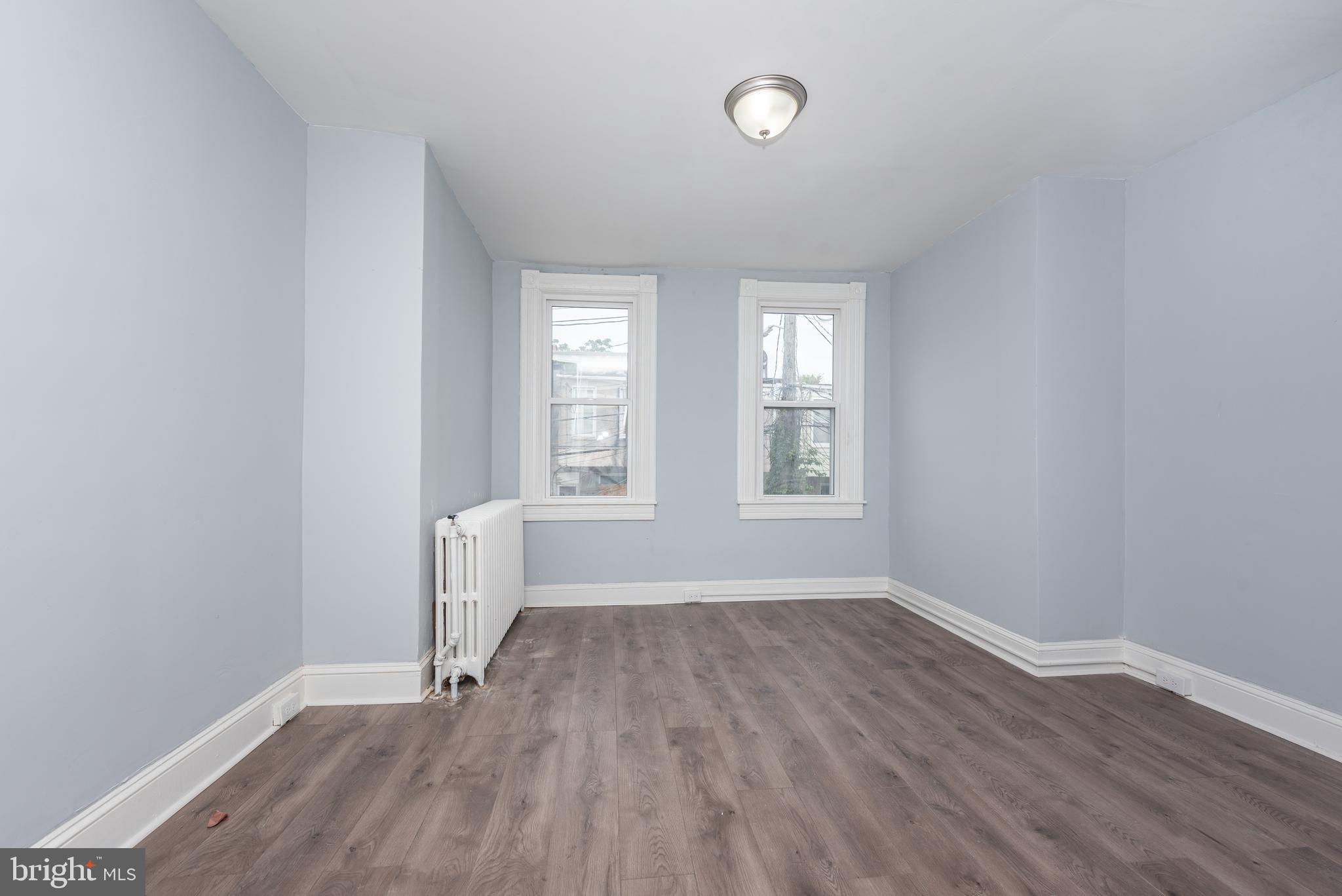 1624 Darley Avenue Baltimore, MD 21213 - Photo 24 of 28 an empty room with wooden floor and windows