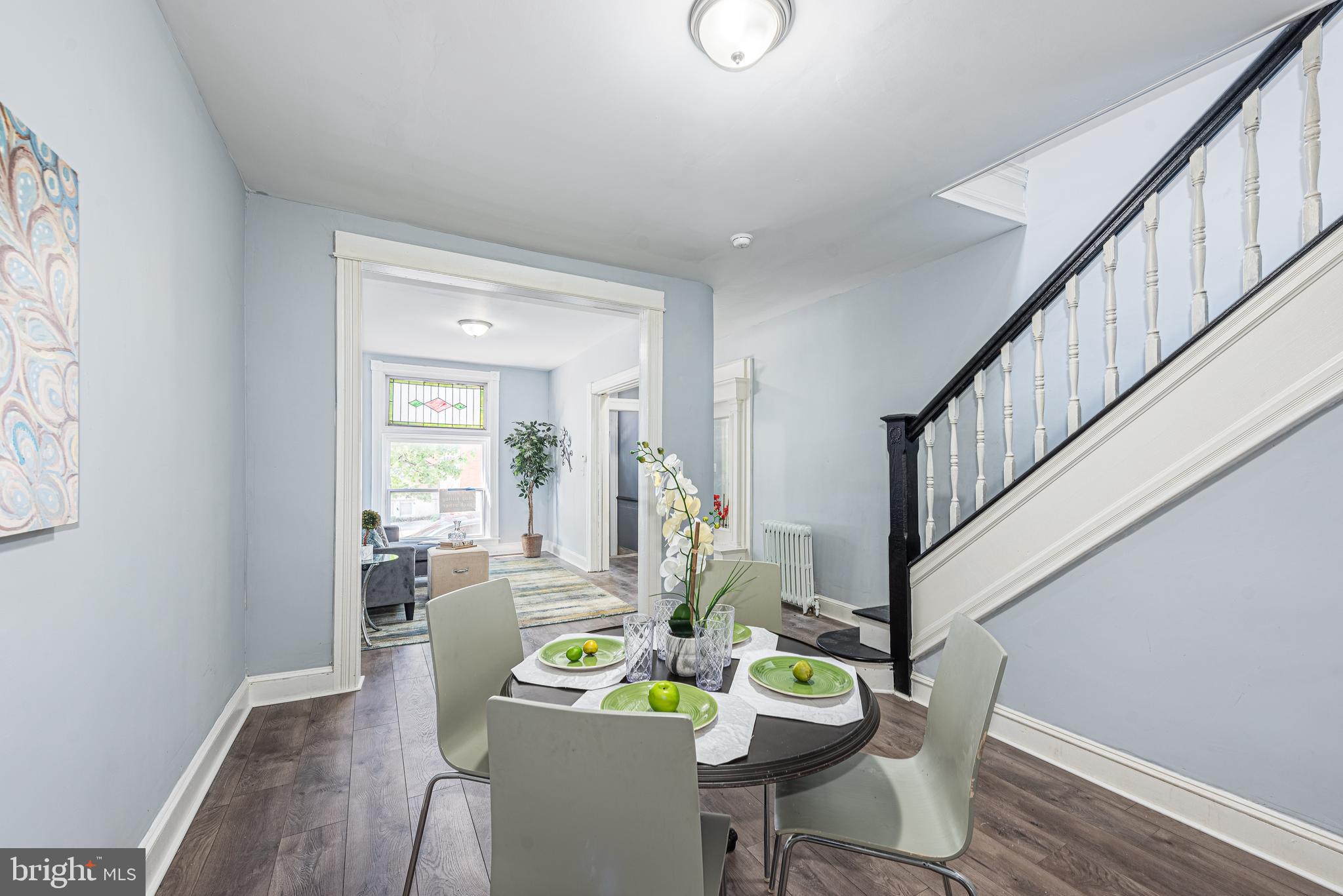 1624 Darley Avenue Baltimore, MD 21213 - Photo 7 of 28 a view of a dining room with furniture a potted plant and wooden floor