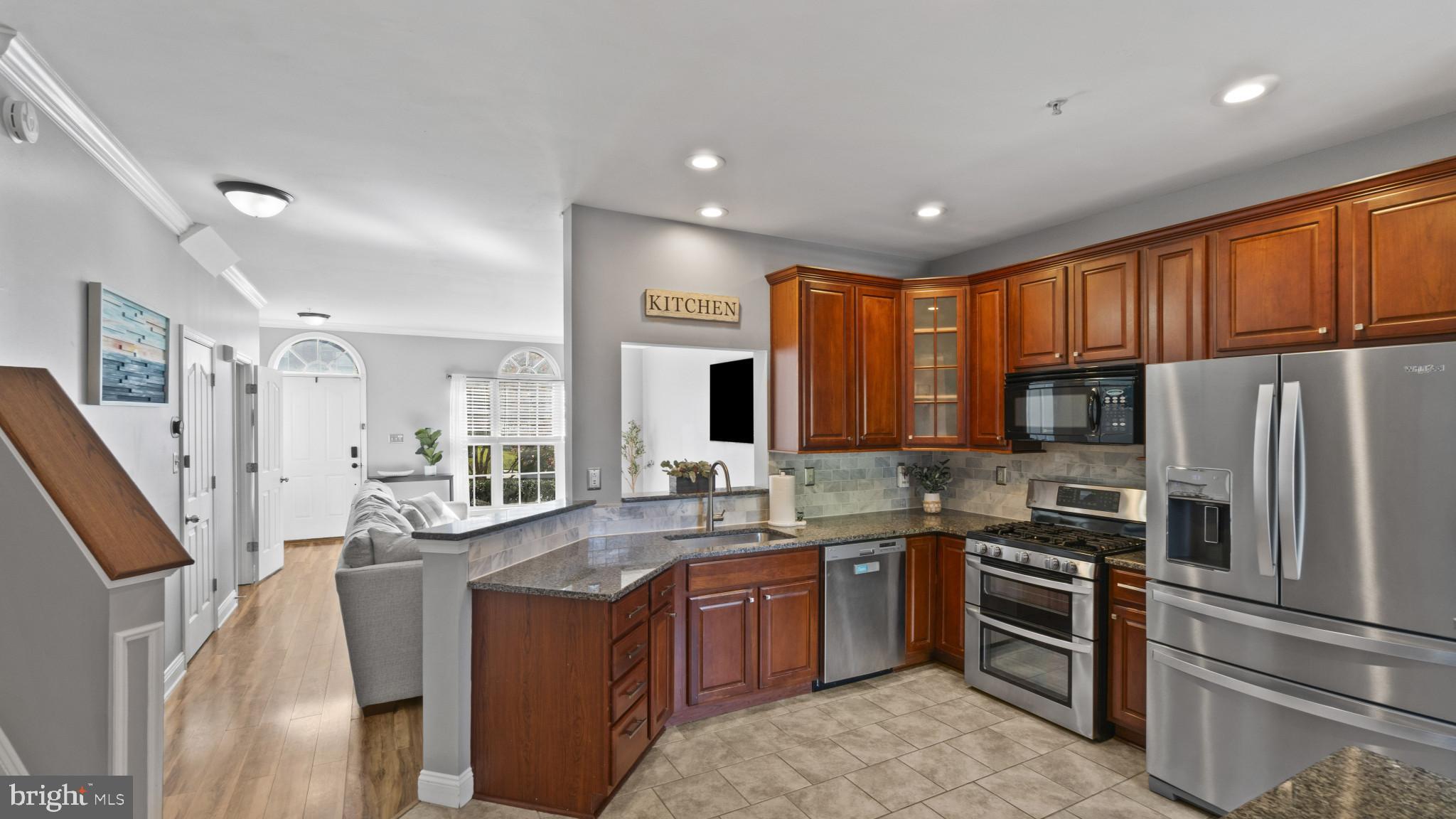 526 Callander Way Abingdon, MD 21009 - Photo 11 of 40 a kitchen with stainless steel appliances granite countertop a refrigerator a sink dishwasher a stove and a refrigerator with wooden floor