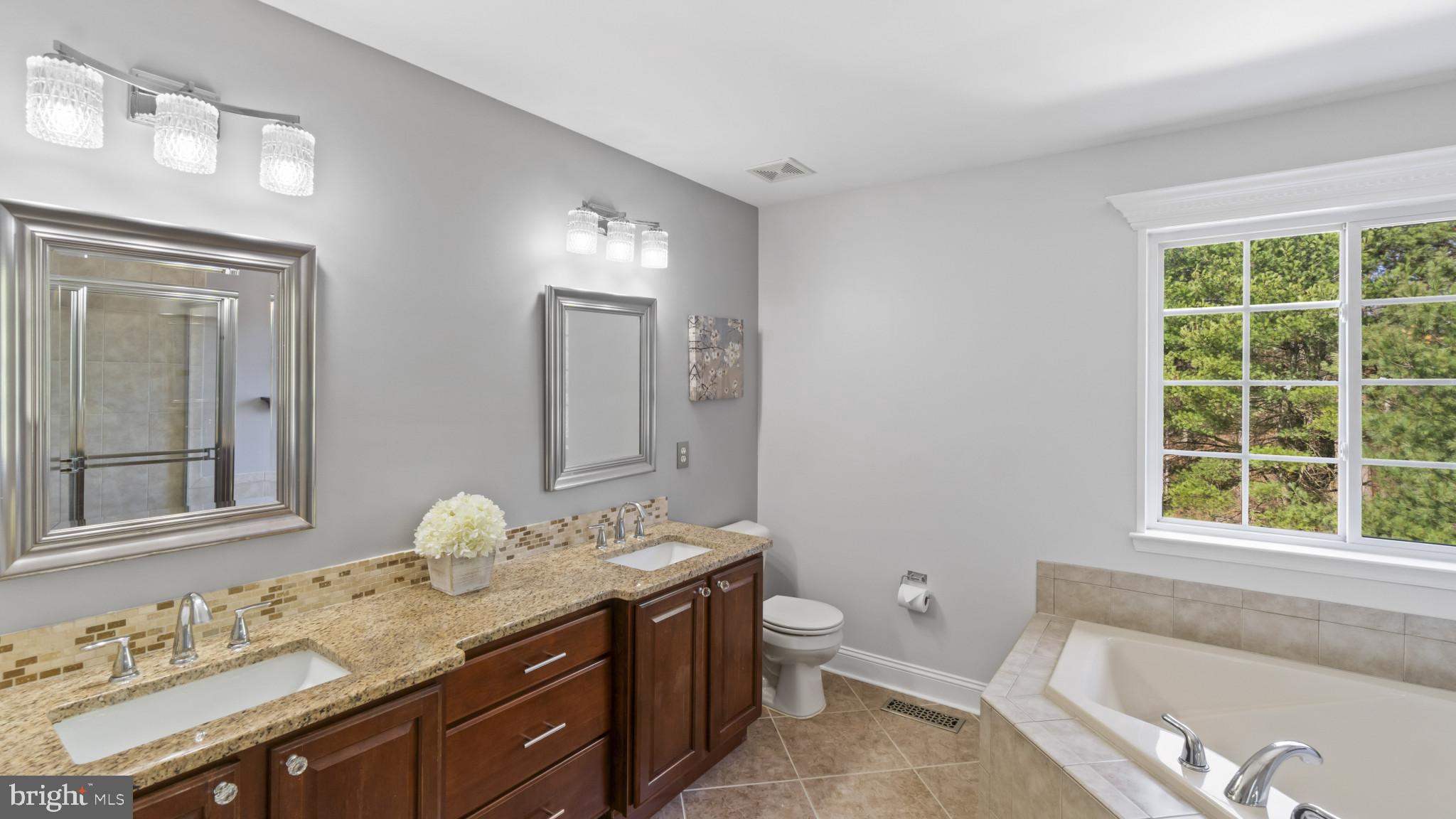 526 Callander Way Abingdon, MD 21009 - Photo 17 of 40 a spacious bathroom with a granite countertop toilet a sink and a bathtub