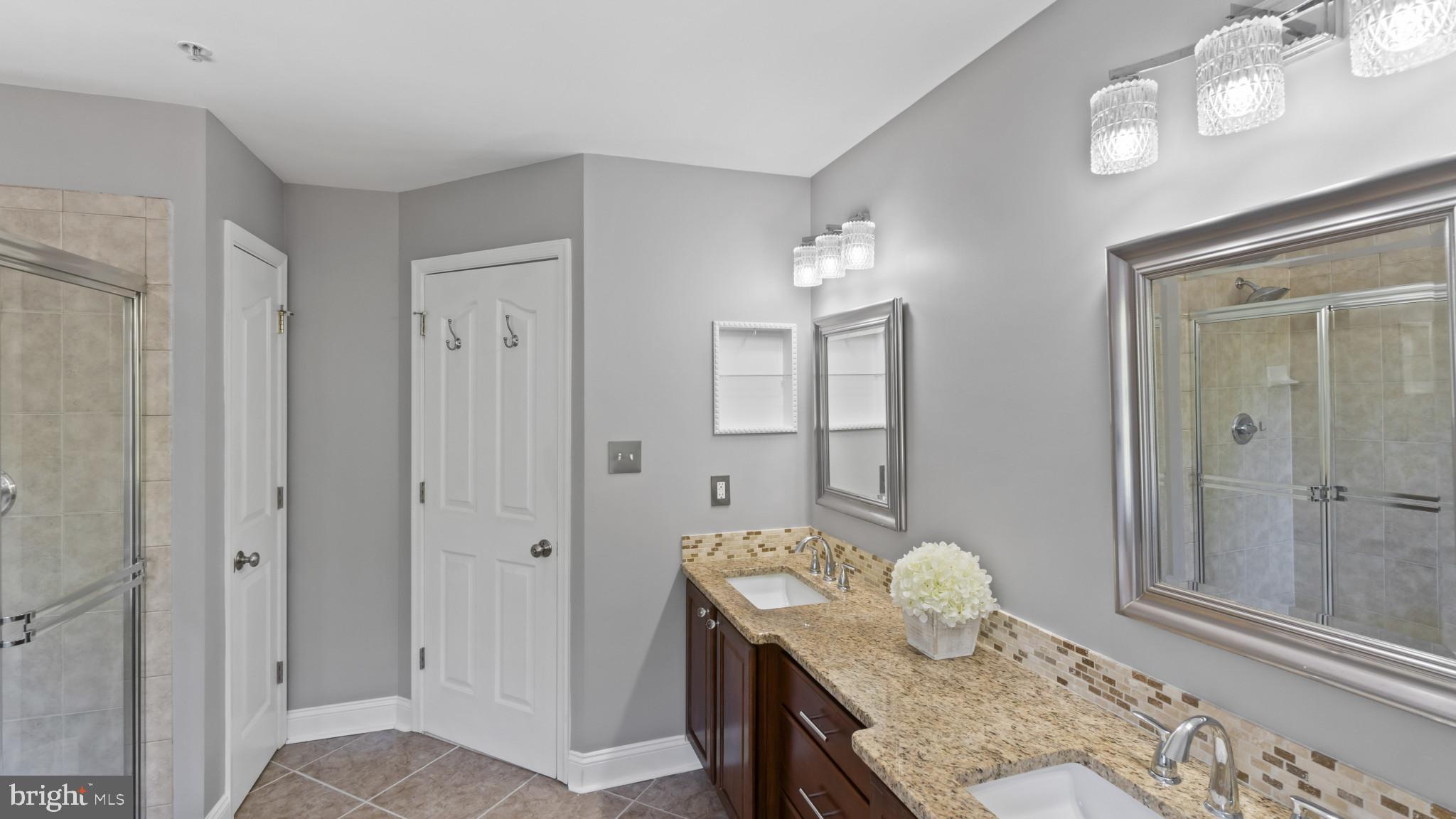 526 Callander Way Abingdon, MD 21009 - Photo 18 of 40 a en suite bathroom with a granite countertop sink a mirror and shower