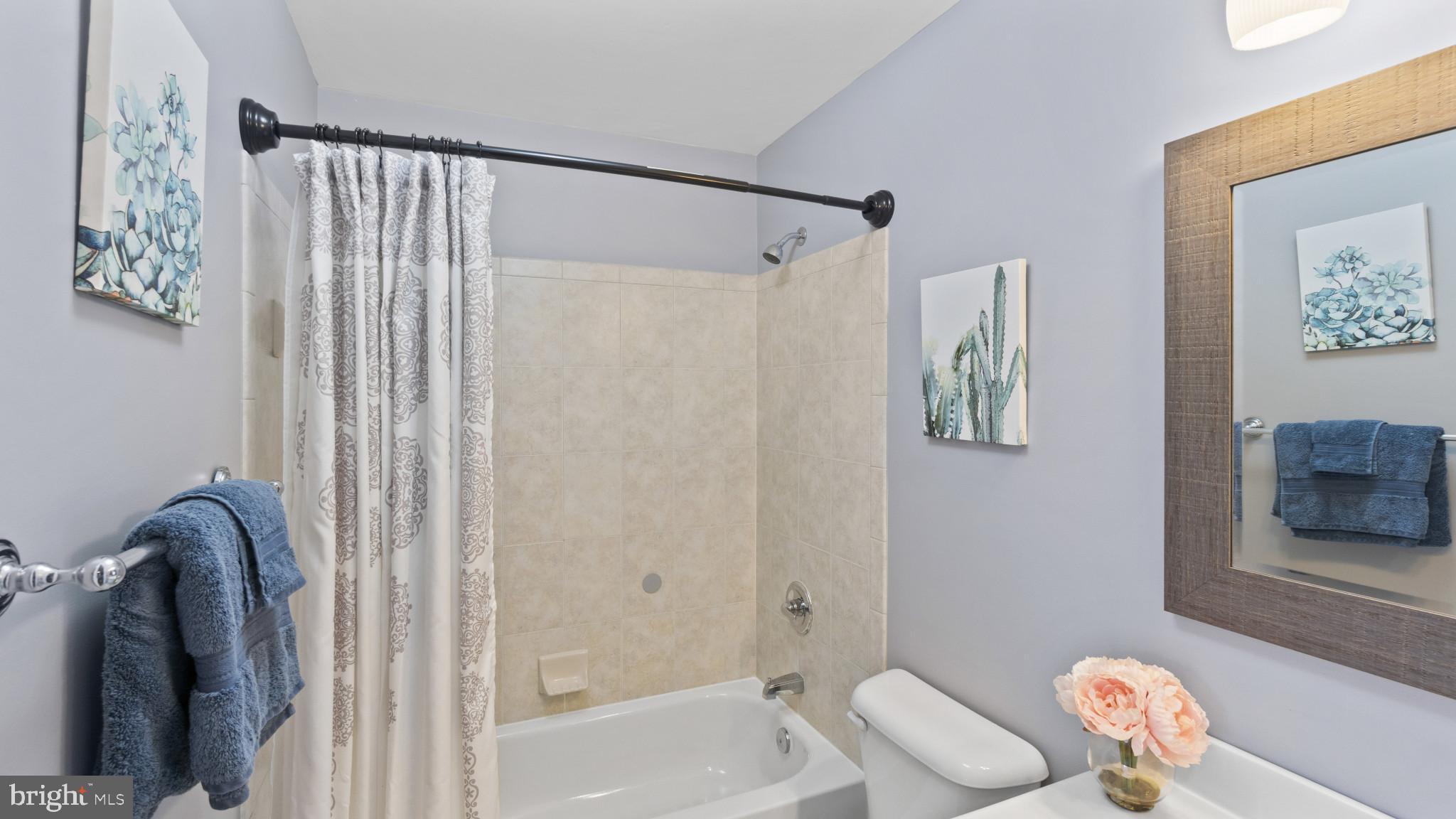 526 Callander Way Abingdon, MD 21009 - Photo 25 of 40 a bathroom with a shower curtain and a sink