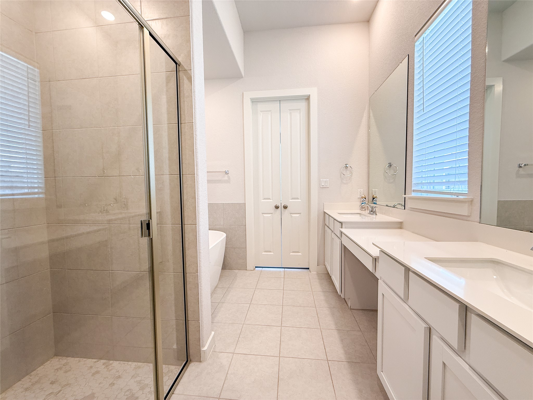 249 Heartleaf Road San Marcos, TX 78666 - Photo 14 of 38 Dual vanities and a spacious glass-enclosed shower create a serene bath retreat.
