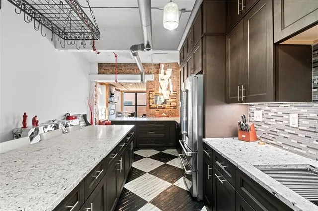 a kitchen with stainless steel appliances granite countertop a sink stove and refrigerator