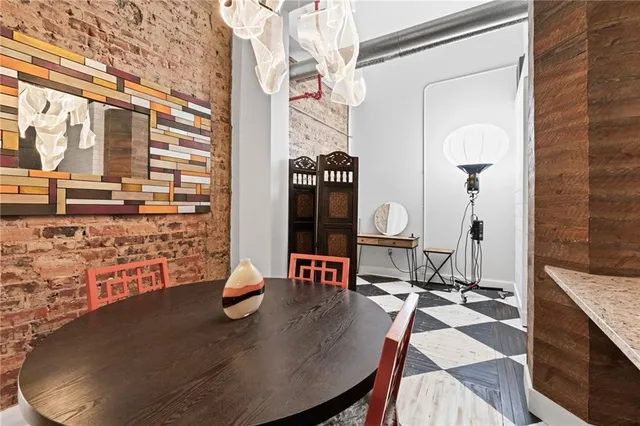 a view of a workspace with furniture and a potted plant