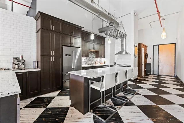 a kitchen with stainless steel appliances a stove a refrigerator and cabinets