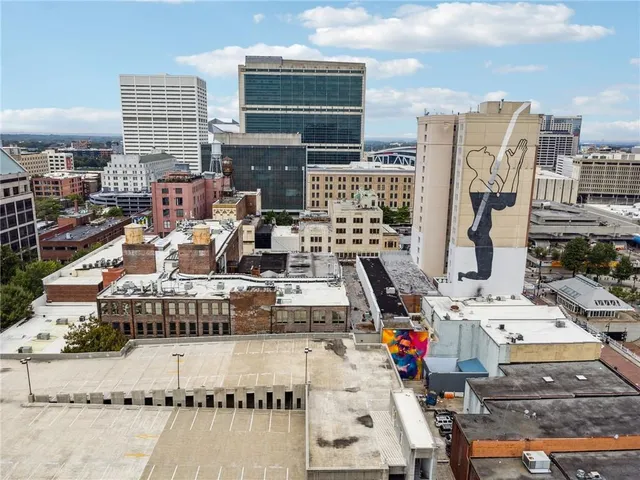 a roof deck with wooden floor and fence