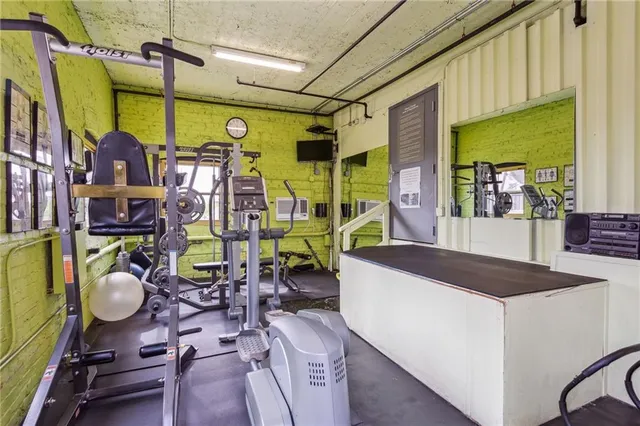 a black and white building with trees in the background