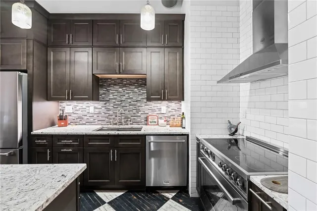 a kitchen with a sink stove and cabinets