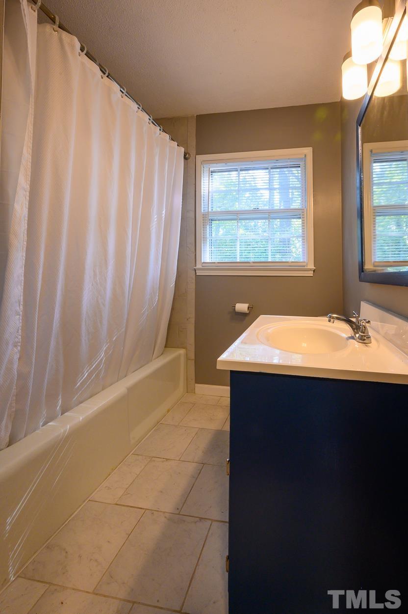 4208 Waterbury Road Raleigh, NC 27604 - Photo 14 of 24 a bathroom with a sink and a mirror