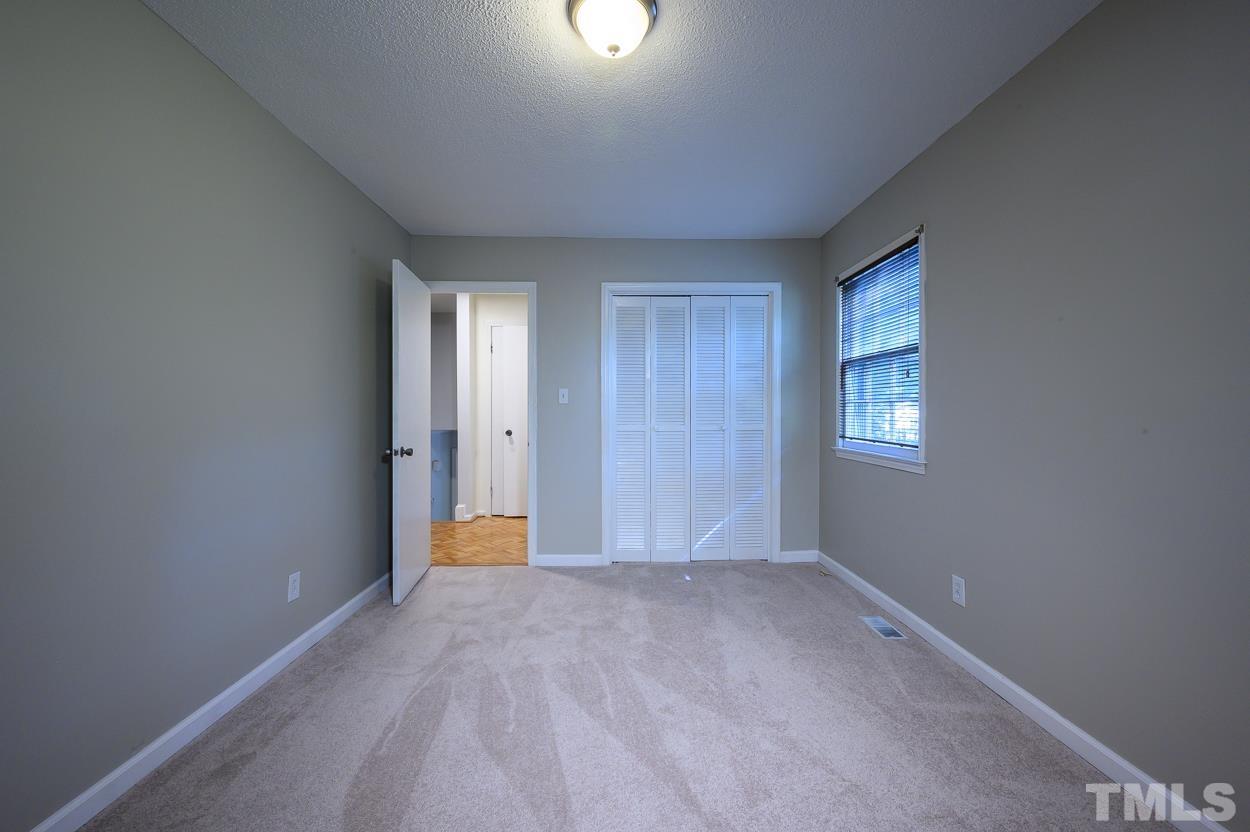 4208 Waterbury Road Raleigh, NC 27604 - Photo 15 of 24 a view of an empty room with a window