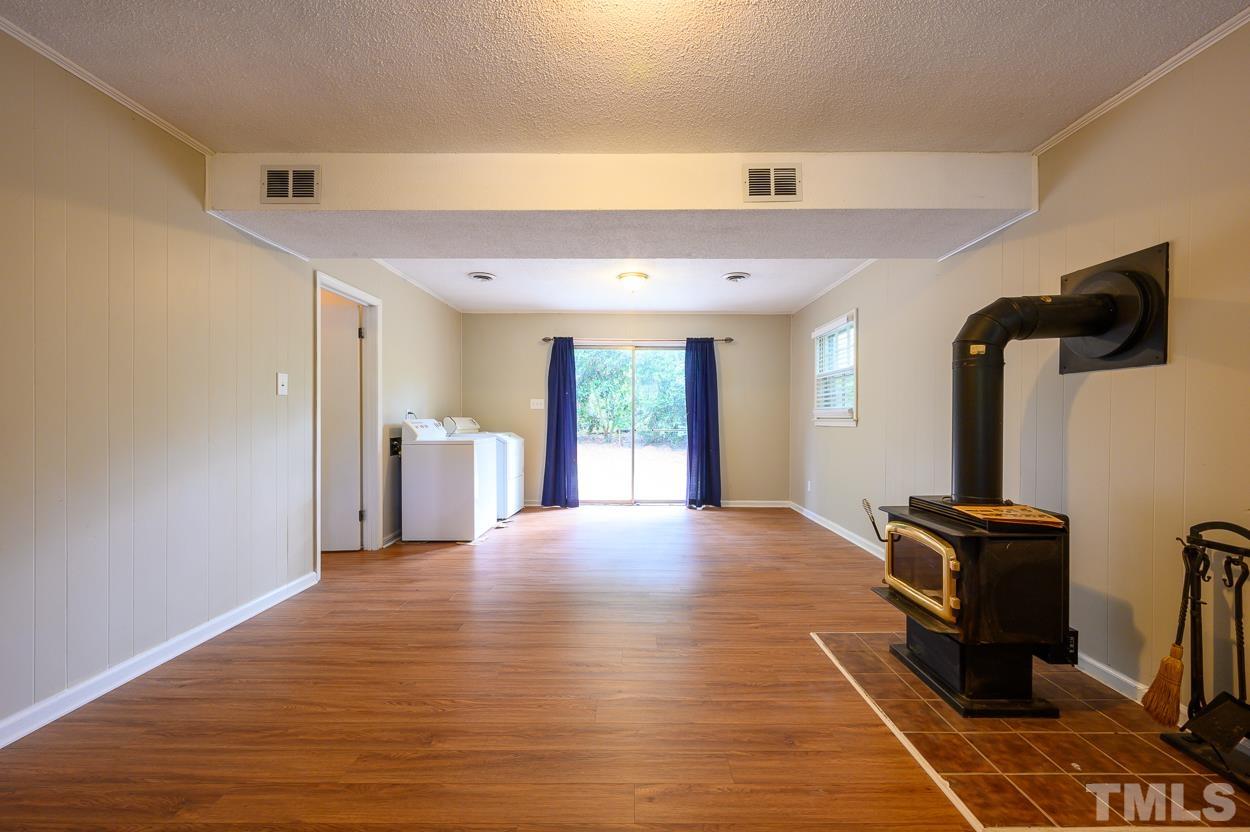 4208 Waterbury Road Raleigh, NC 27604 - Photo 19 of 24 a view of an empty room with window and hardwood floor