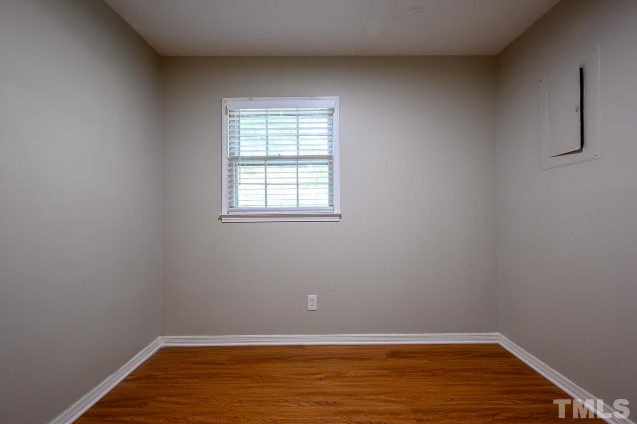 4208 Waterbury Road Raleigh, NC 27604 - Photo 21 of 24 an empty room with wooden floor and windows