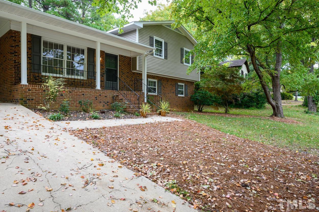 4208 Waterbury Road Raleigh, NC 27604 - Photo 4 of 24 a front view of a house with a yard and potted plants