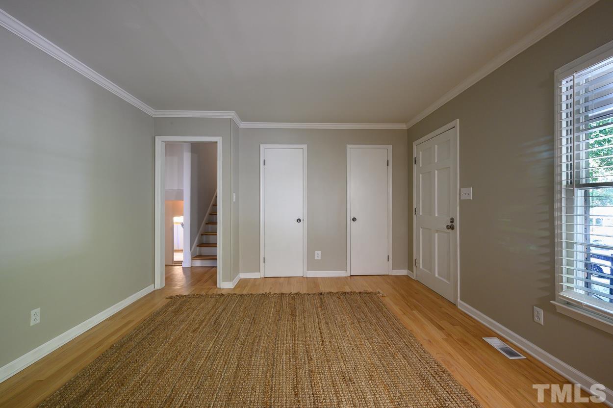 4208 Waterbury Road Raleigh, NC 27604 - Photo 8 of 24 an empty room with wooden floor and windows