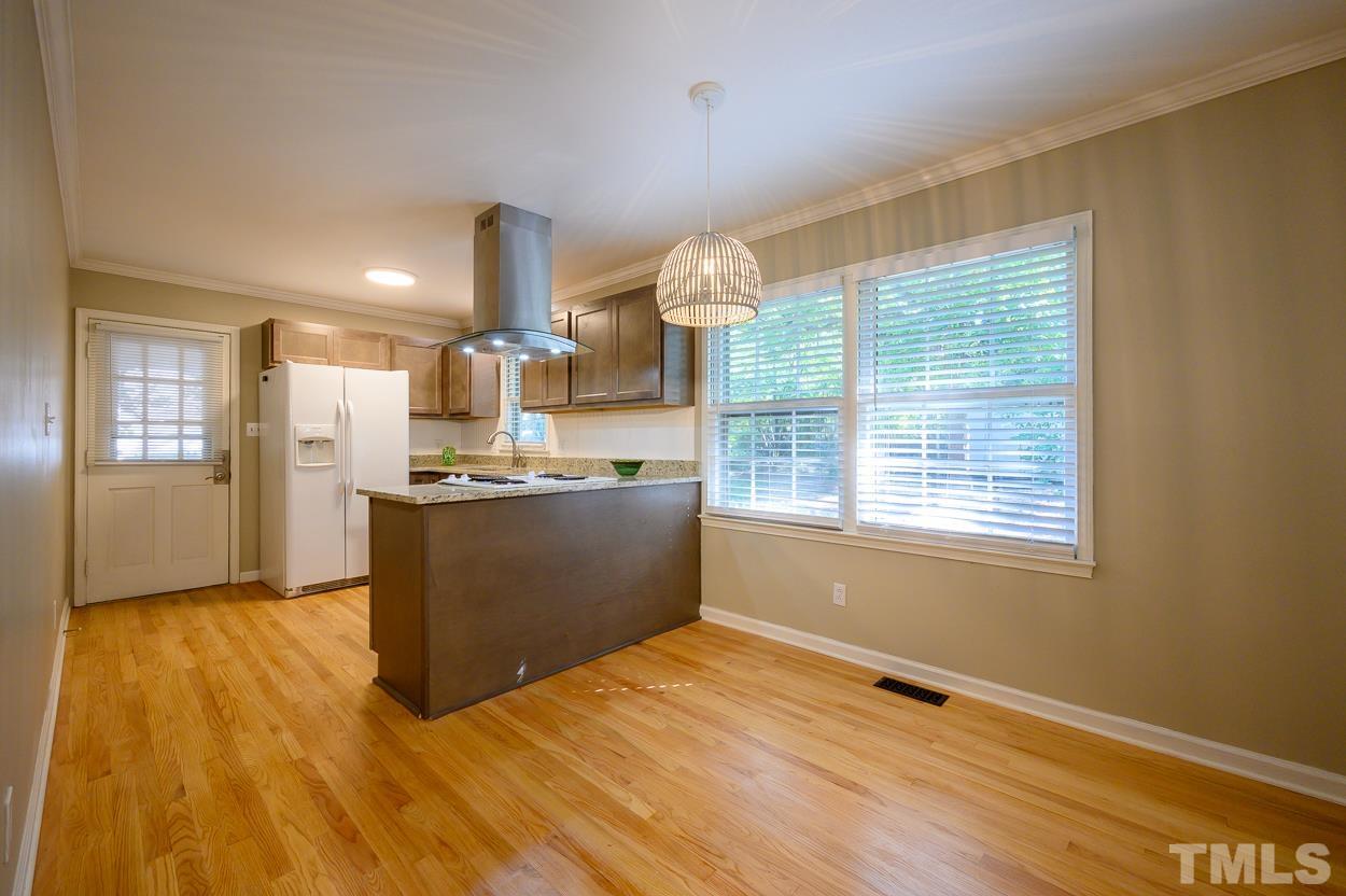 4208 Waterbury Road Raleigh, NC 27604 - Photo 9 of 24 a view of open kitchen with wooden floor and outdoor space