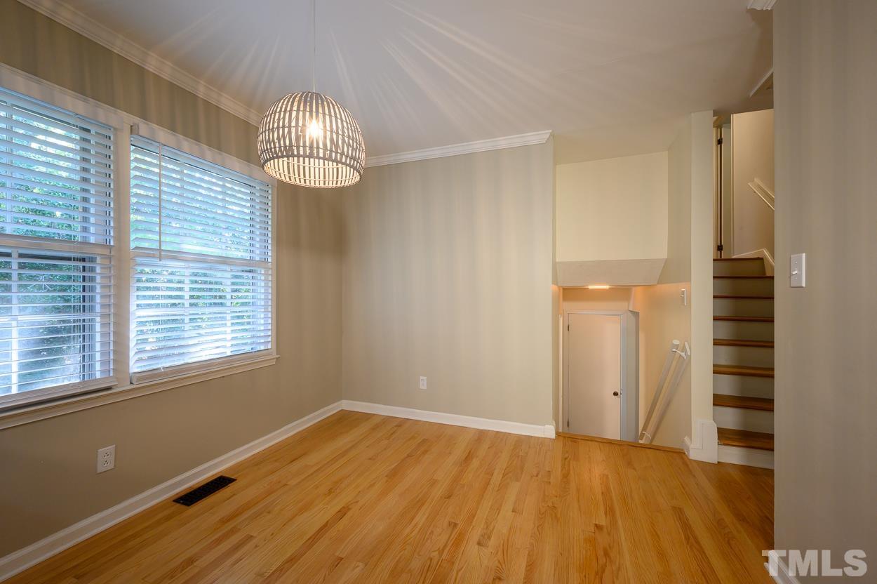 4208 Waterbury Road Raleigh, NC 27604 - Photo 10 of 24 a view of empty room with wooden floor and fan