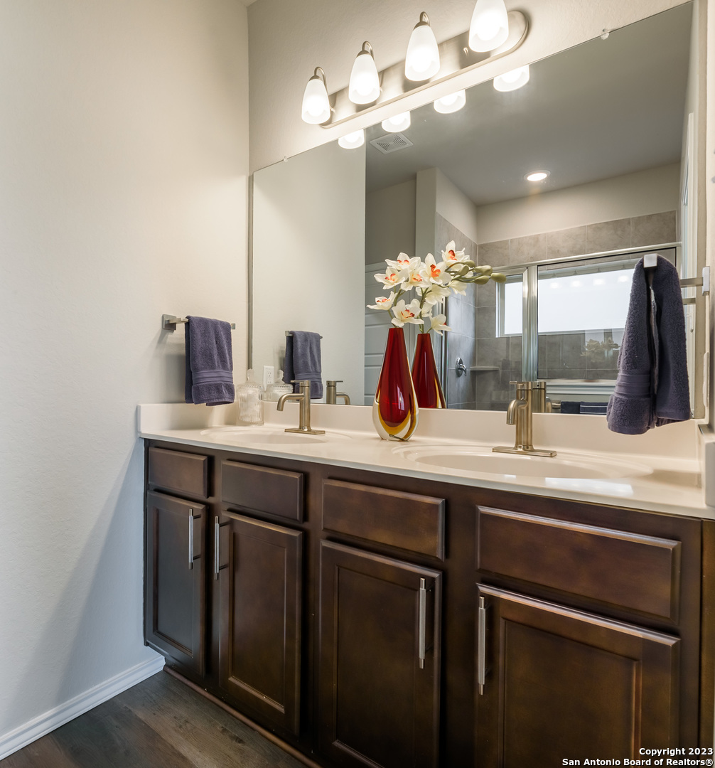1609 Ranch House New Braunfels, TX 78132 - Photo 16 of 39 a bathroom with a sink a large mirror and vanity