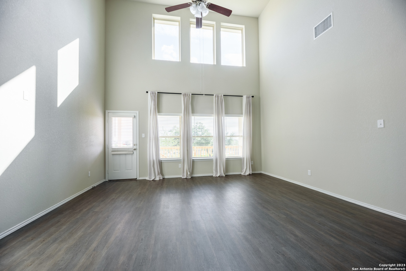 1609 Ranch House New Braunfels, TX 78132 - Photo 3 of 39 an empty room with wooden floor and windows
