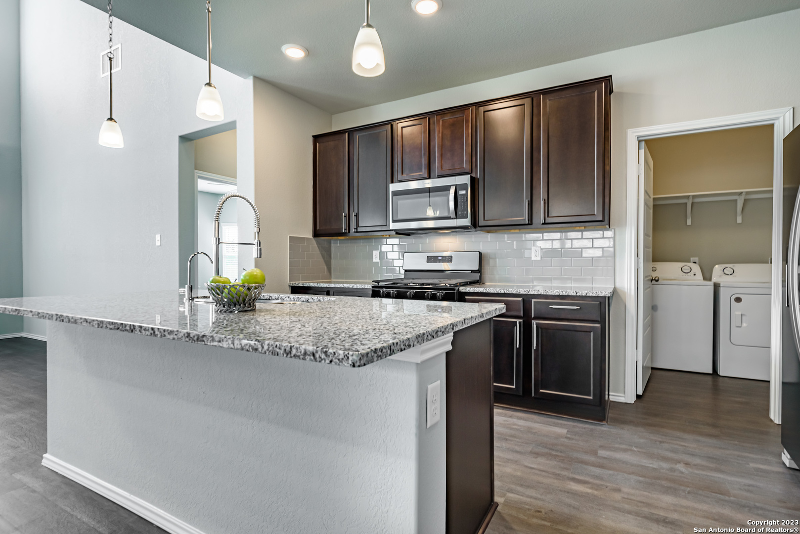 1609 Ranch House New Braunfels, TX 78132 - Photo 6 of 39 a kitchen with stainless steel appliances granite countertop a stove a sink and a refrigerator