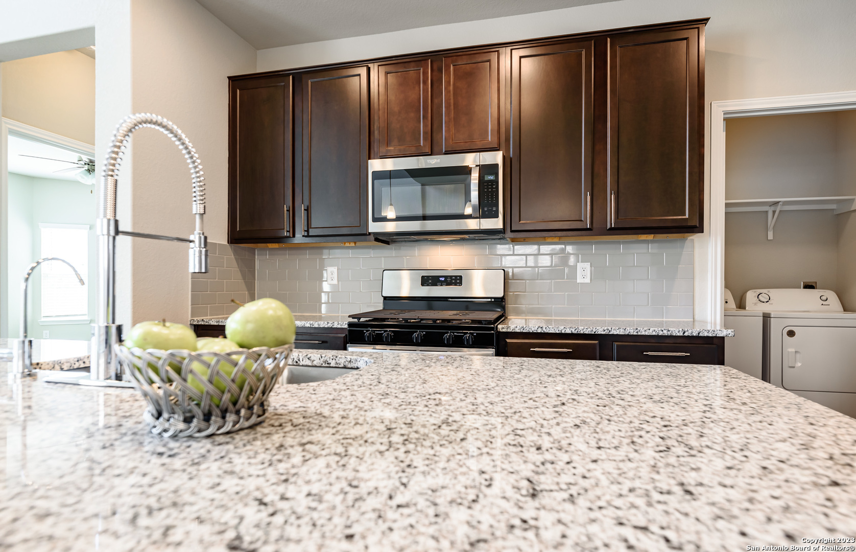 1609 Ranch House New Braunfels, TX 78132 - Photo 8 of 39 a kitchen with a stove a microwave and refrigerator