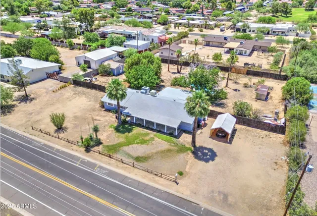 an aerial view of a house with a yard and lake view