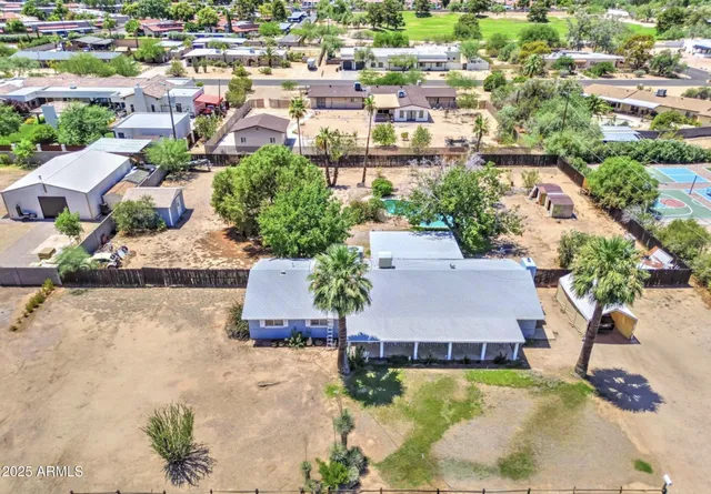 an aerial view of residential houses with yard
