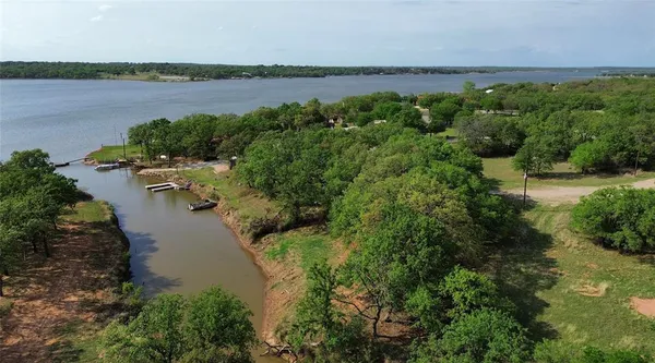 a view of a lake with outdoor space and trees all around