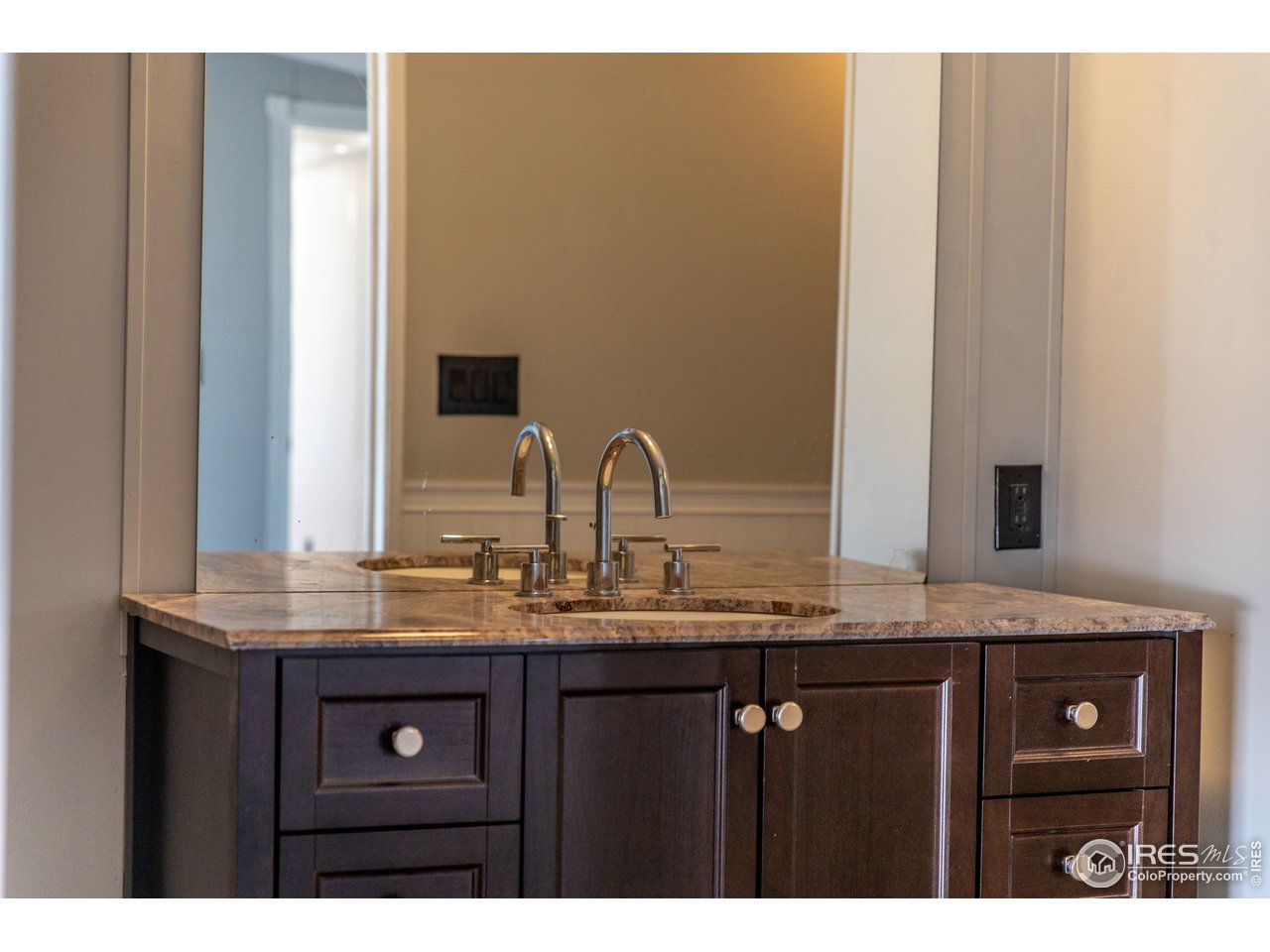 4904 Eagle Crest Boulevard, Unit 221 Firestone, CO 80504 - Photo 13 of 25 a bathroom with a granite countertop sink and a mirror