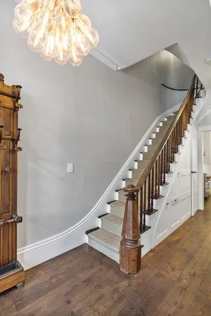 a view of entryway and hall with wooden floor